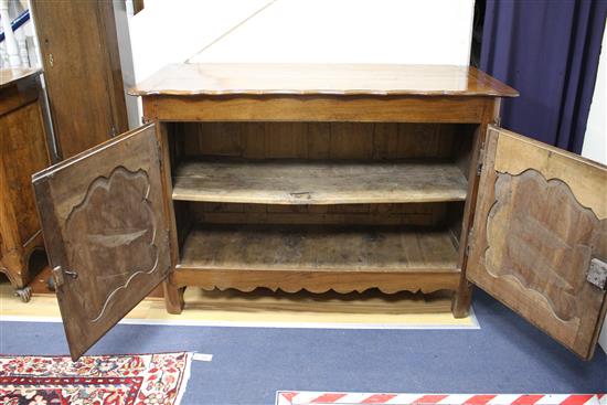An 18th century French provincial walnut cabinet, with serpentine top and two panelled doors, W.138cm D.63cm H.95cm